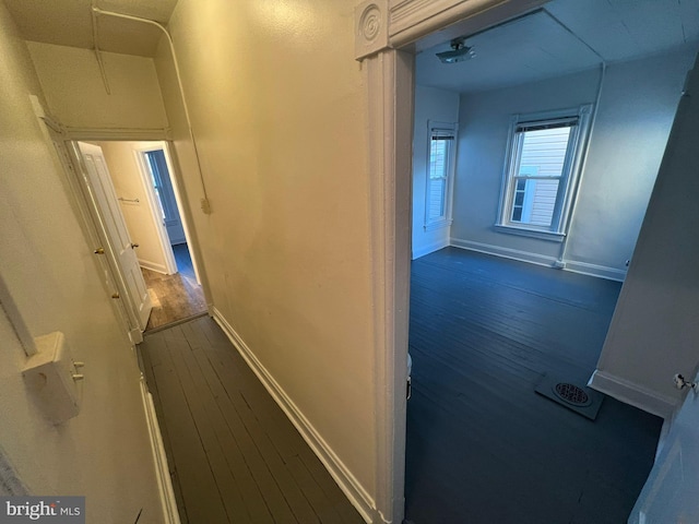 corridor with dark hardwood / wood-style flooring