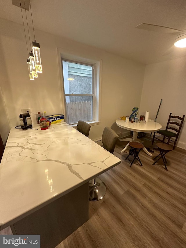 dining space with wood finished floors