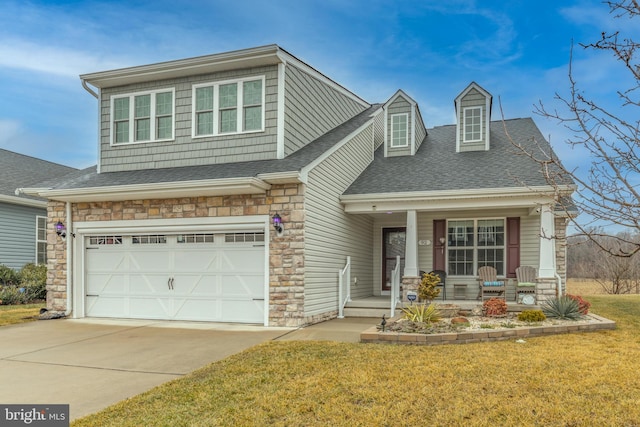 view of front of house with a garage, a front lawn, and a porch