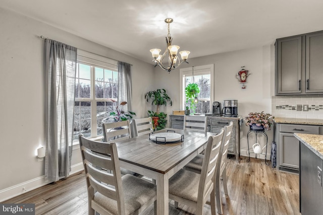 dining space featuring a chandelier and light hardwood / wood-style flooring