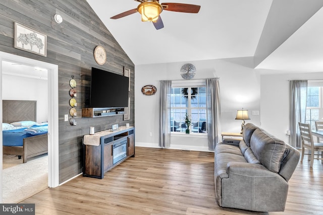 living room with high vaulted ceiling, light hardwood / wood-style floors, and ceiling fan