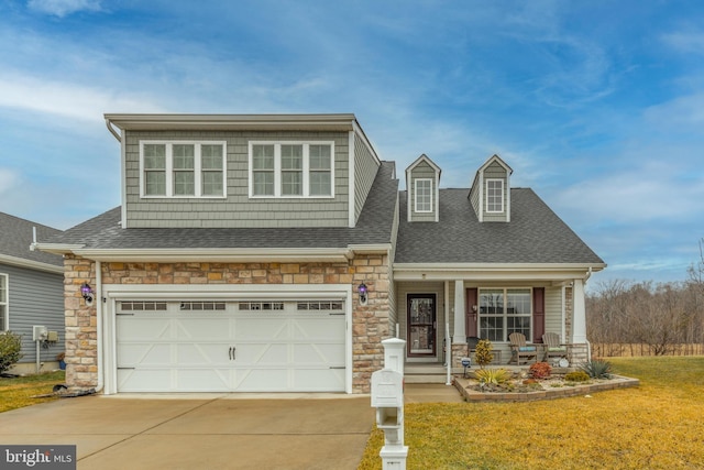 view of front of house with a garage, a front lawn, and covered porch