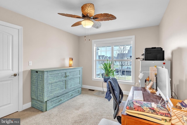 carpeted office featuring ceiling fan