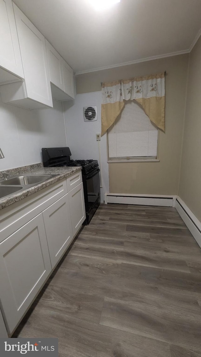 kitchen featuring white cabinets, crown molding, black range with gas cooktop, and dark wood-type flooring