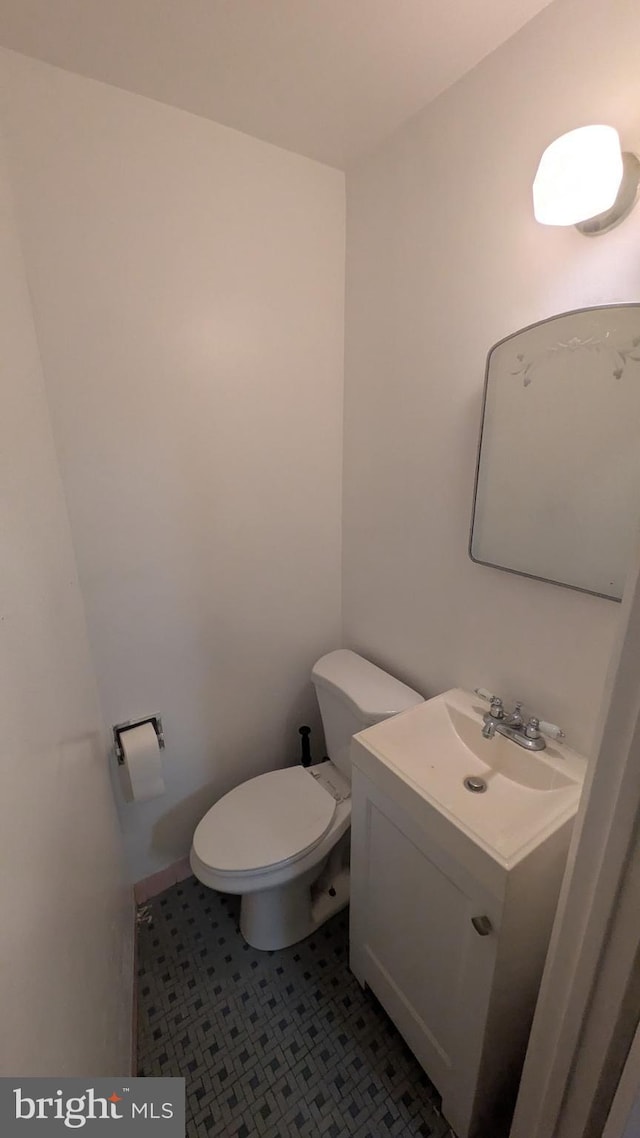 bathroom with tile patterned floors, vanity, and toilet