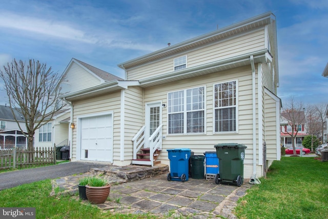view of front of property with entry steps, an attached garage, and driveway