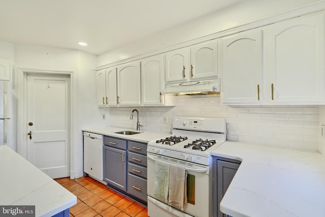 kitchen with sink, white cabinetry, white appliances, light stone countertops, and backsplash