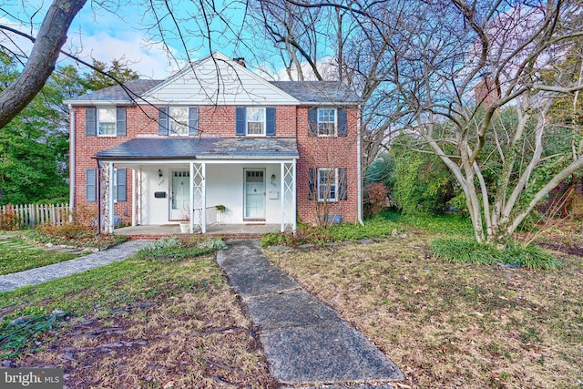 view of front of house with a front yard and a porch