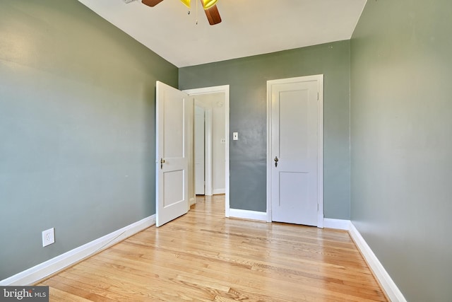 unfurnished bedroom with ceiling fan and light wood-type flooring