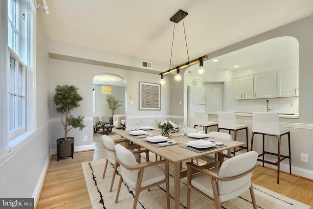 dining room featuring sink and light wood-type flooring