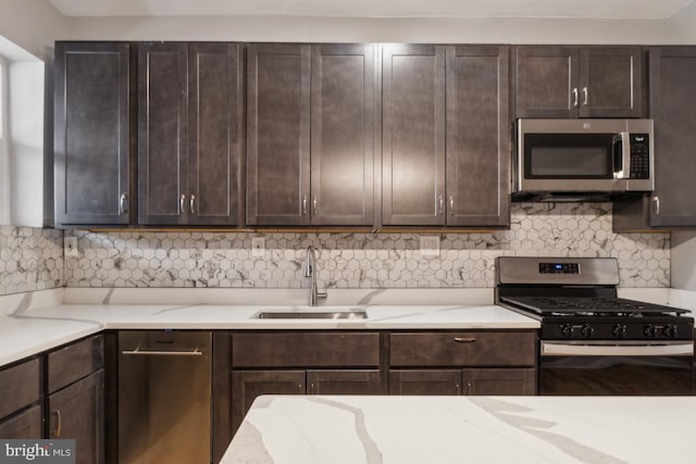 kitchen featuring stainless steel appliances, sink, and dark brown cabinetry