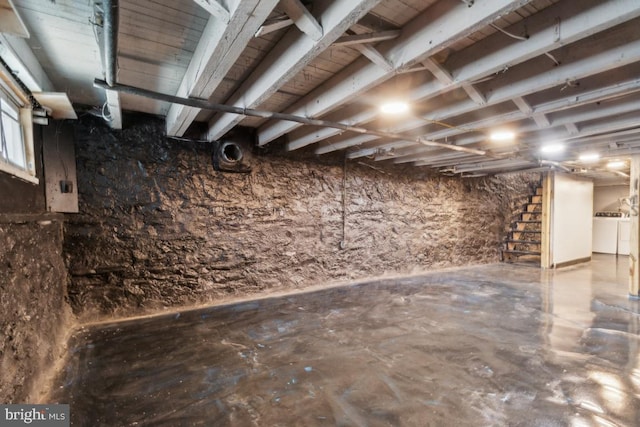 basement featuring washing machine and clothes dryer