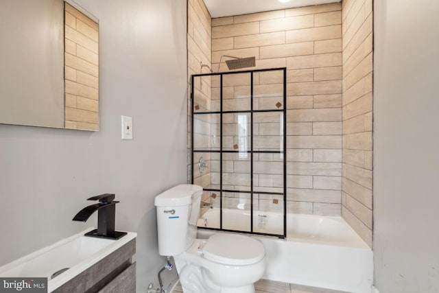 full bathroom featuring sink, shower / bath combination with glass door, and toilet