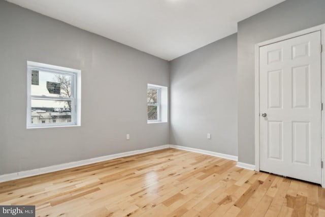 unfurnished room with light wood-type flooring