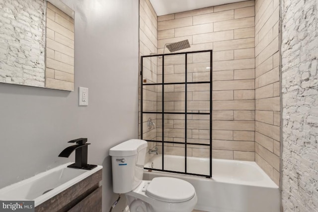 full bathroom with bath / shower combo with glass door, sink, and toilet