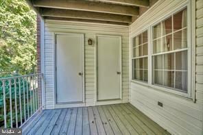 view of exterior entry with a balcony