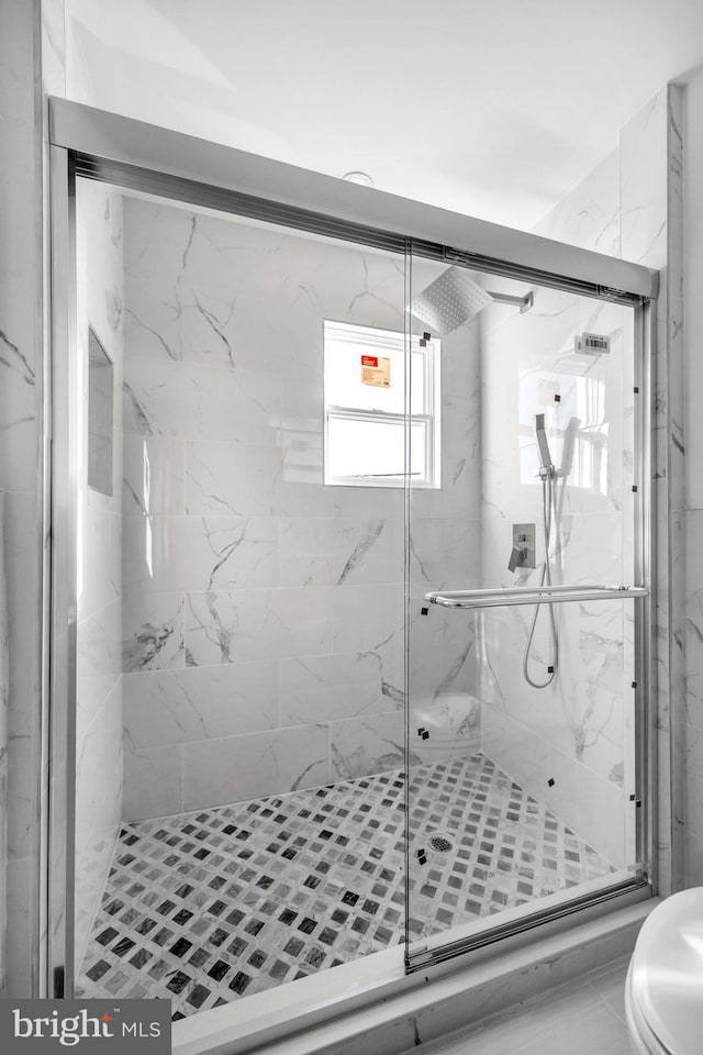 bathroom featuring an enclosed shower