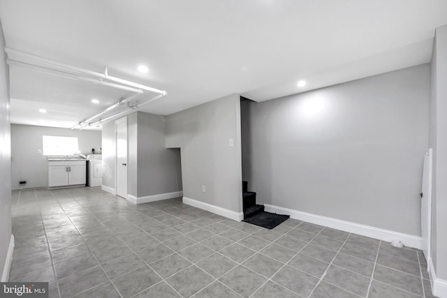 basement with washer / clothes dryer and light tile patterned flooring