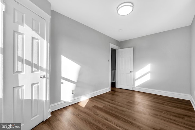 unfurnished bedroom featuring dark wood-type flooring