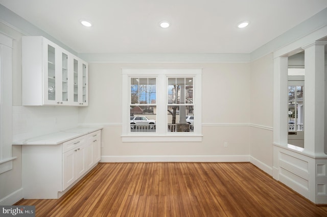 unfurnished dining area with wood-type flooring