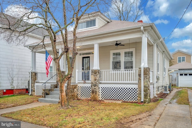 bungalow-style home with ceiling fan, a garage, and covered porch