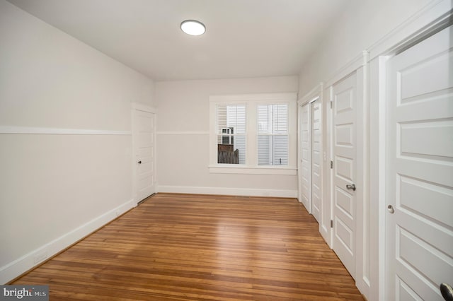 empty room with hardwood / wood-style flooring