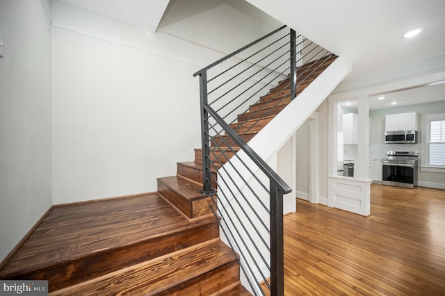 stairs with hardwood / wood-style flooring