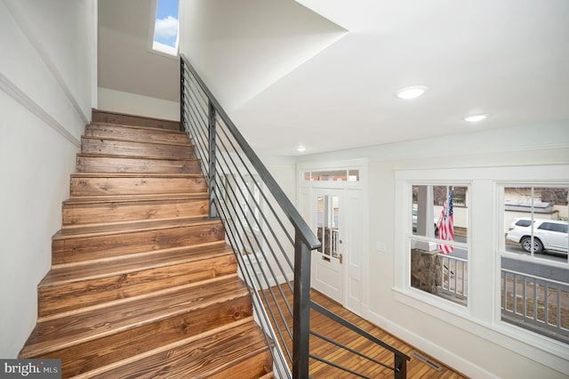 staircase featuring wood-type flooring