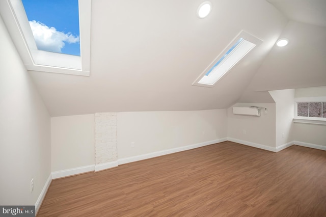 additional living space with lofted ceiling and hardwood / wood-style floors