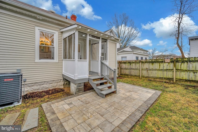 view of patio / terrace with a sunroom and central air condition unit