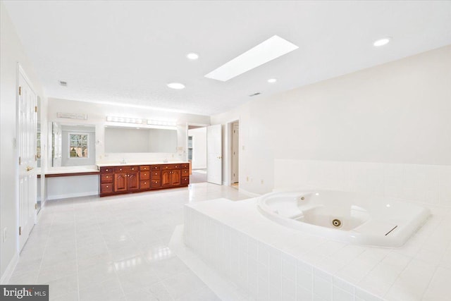 full bathroom featuring a skylight, double vanity, recessed lighting, tile patterned flooring, and a jetted tub