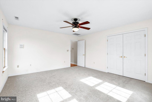 unfurnished bedroom featuring light carpet, visible vents, and baseboards