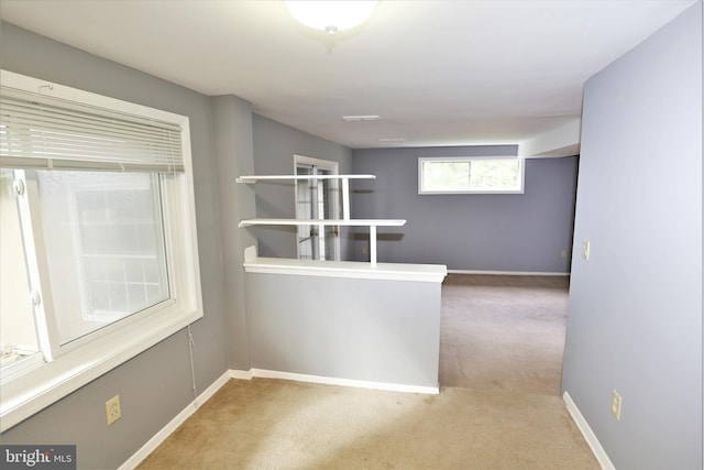 hallway featuring light carpet