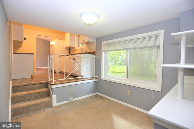 unfurnished dining area featuring carpet