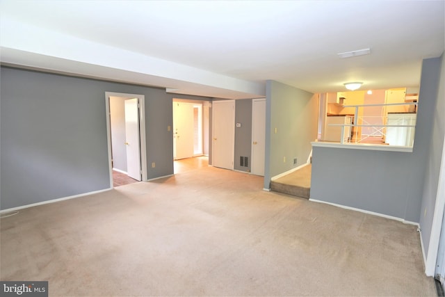 unfurnished living room featuring carpet