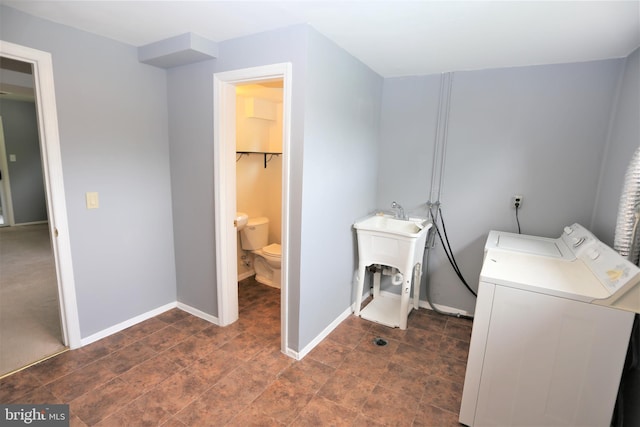 laundry room featuring sink and washer and dryer