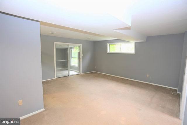 spare room featuring light colored carpet