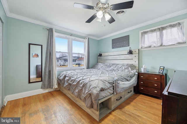 bedroom with light hardwood / wood-style flooring, ornamental molding, and ceiling fan