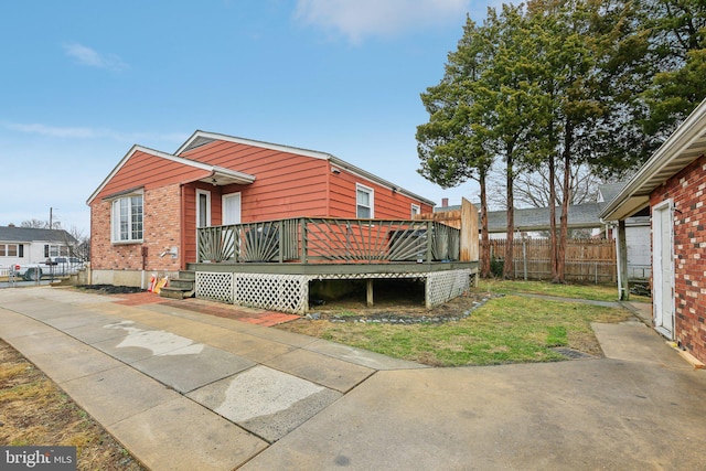 rear view of house featuring a deck