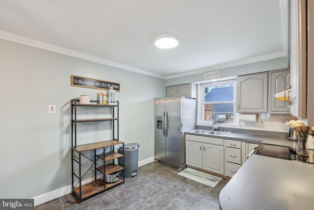 kitchen featuring ornamental molding, sink, gray cabinetry, and stainless steel fridge