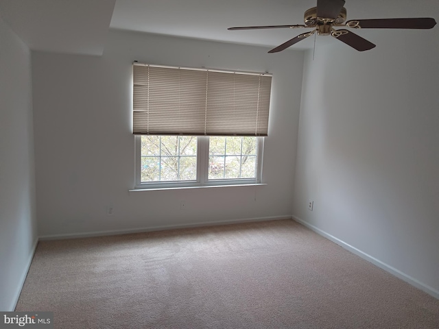 unfurnished room featuring ceiling fan and light carpet