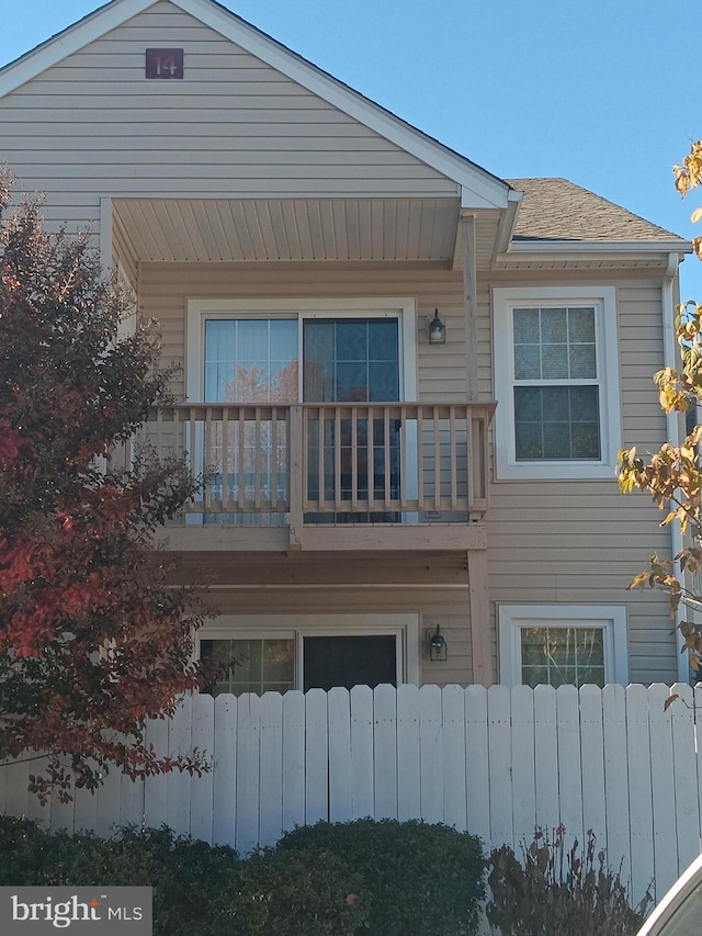 rear view of property featuring a balcony