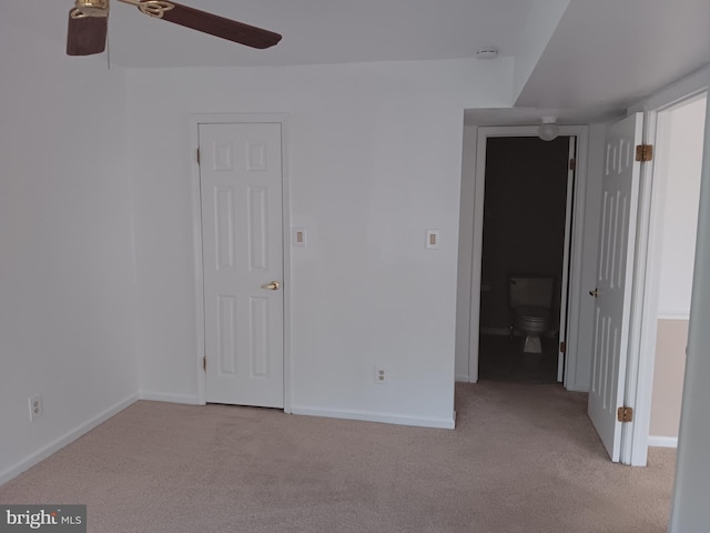 unfurnished room with ceiling fan and light colored carpet