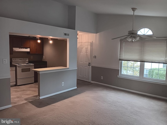 kitchen with kitchen peninsula, light colored carpet, dark brown cabinetry, ceiling fan, and white appliances