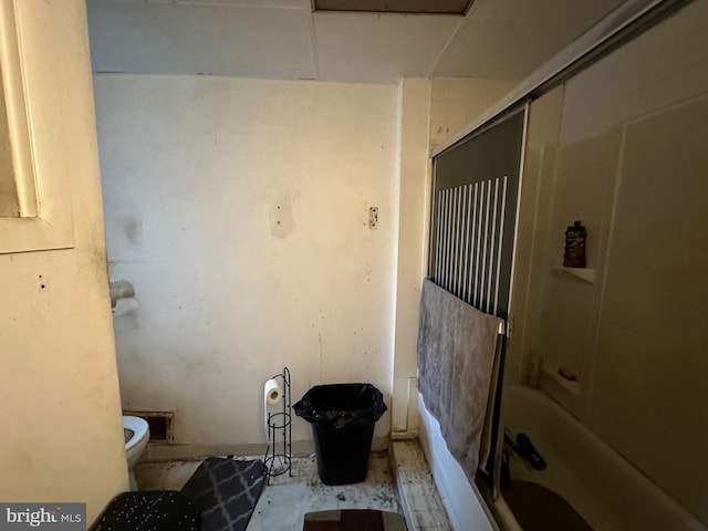 bathroom featuring tub / shower combination and toilet