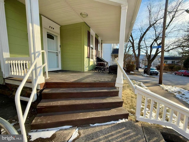 view of exterior entry with a porch