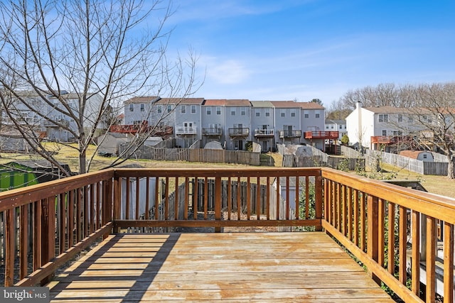 deck with a residential view and fence