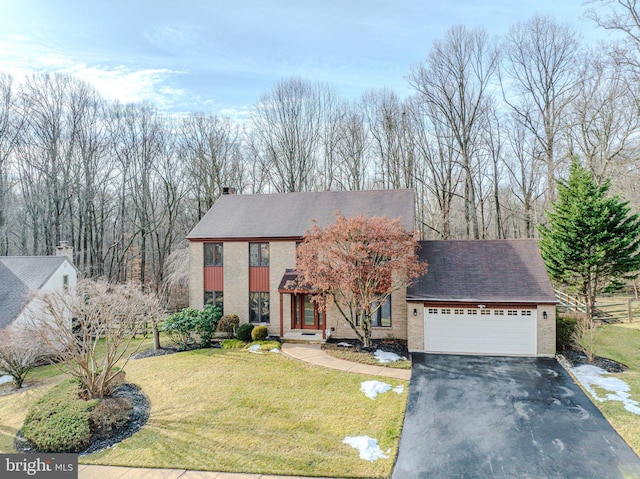 view of front facade with a garage and a front yard