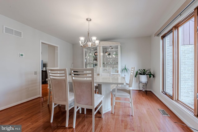 dining room featuring a notable chandelier and light hardwood / wood-style flooring