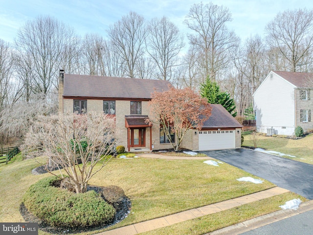 view of front of home with a garage and a front lawn